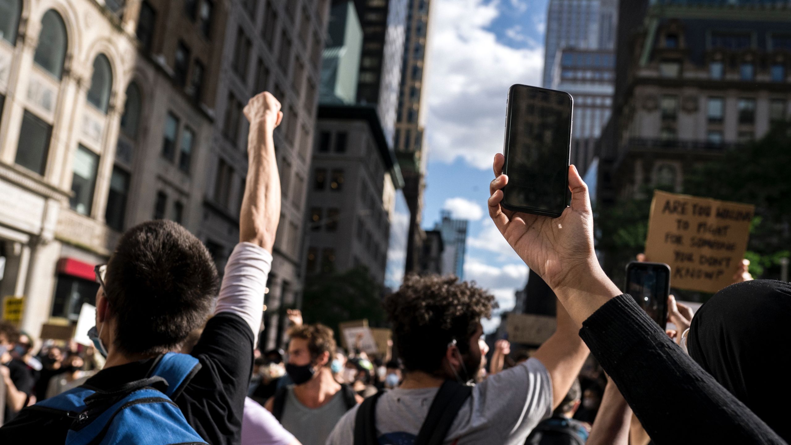 Photo of street protest with phone in air