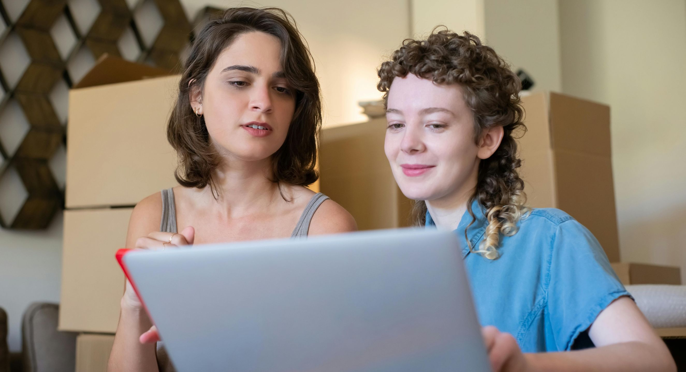 two young women working on laptop
