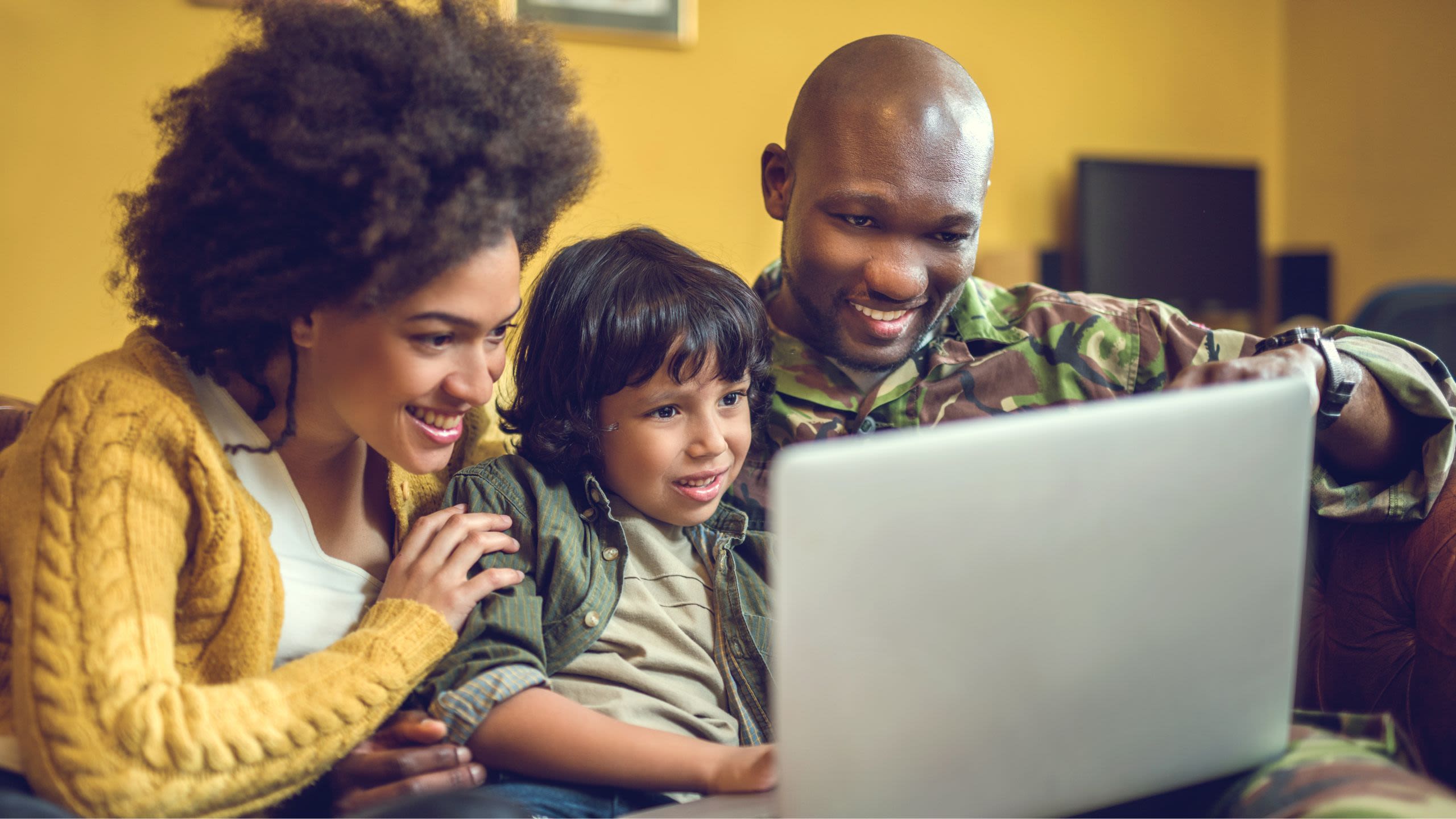 Family Sitting together in front of laptop