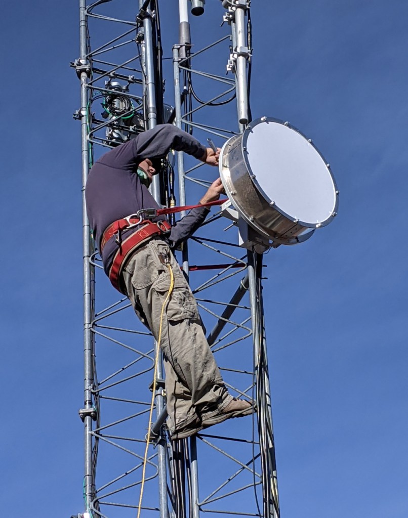 Jim Kossow working on fiber tower